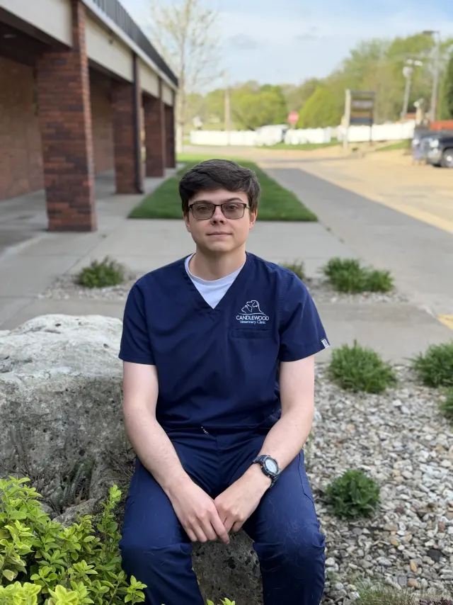 Ian, in navy Candlewood scrubs, outside the clinic