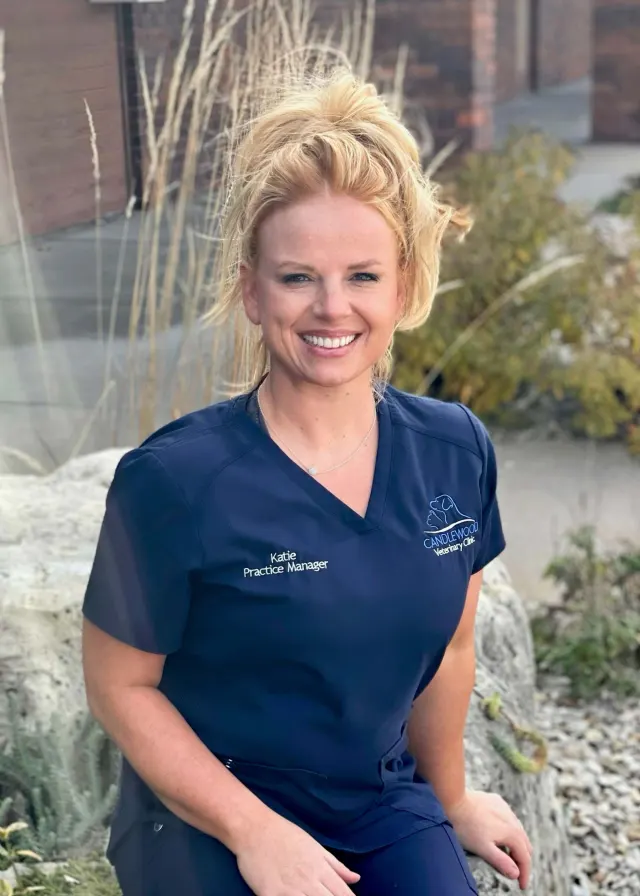 Katie, in navy Candlewood scrubs, outside the clinic